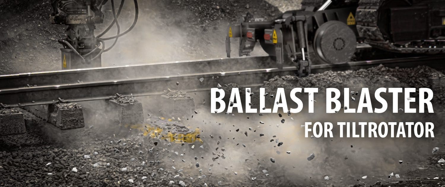 DymaxRail Ballast Blaster Undercutter – Tiltrotator Coupler DymaxRail Ballast Blaster undercutter attachment mounted to tiltrotator coupler on hi-railed excavator