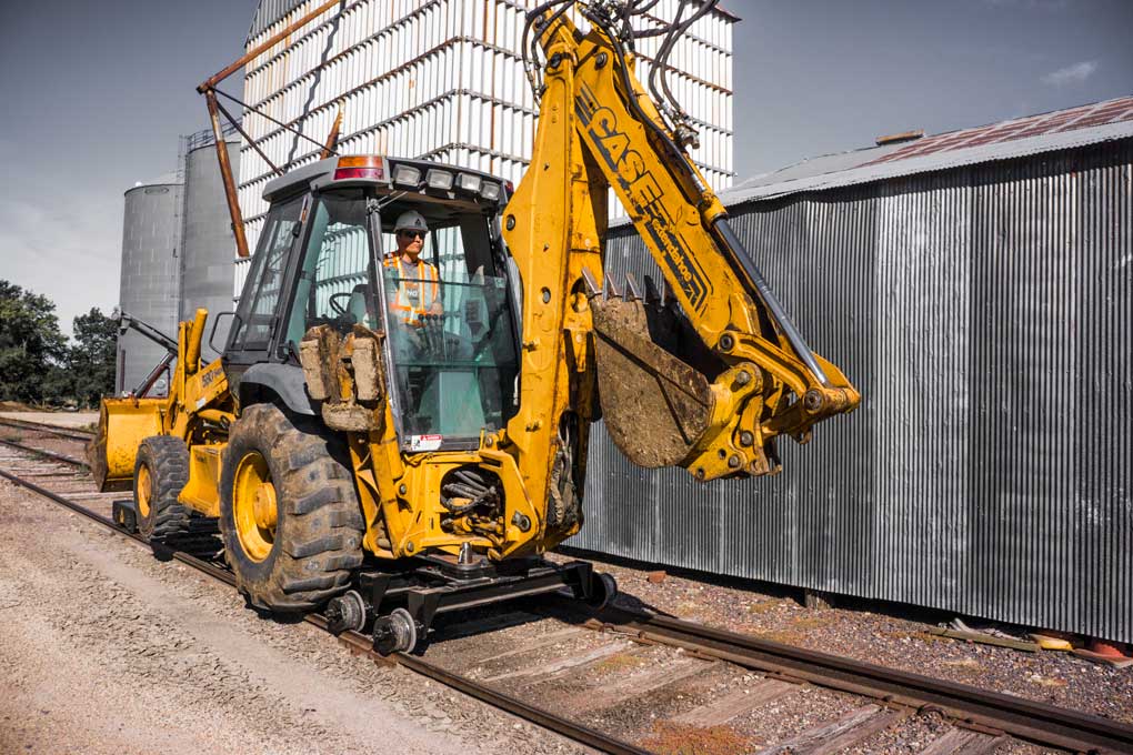 Case 580 or 590 backhoe loader configured for the Dymax Rail Rider hi-rail guide system