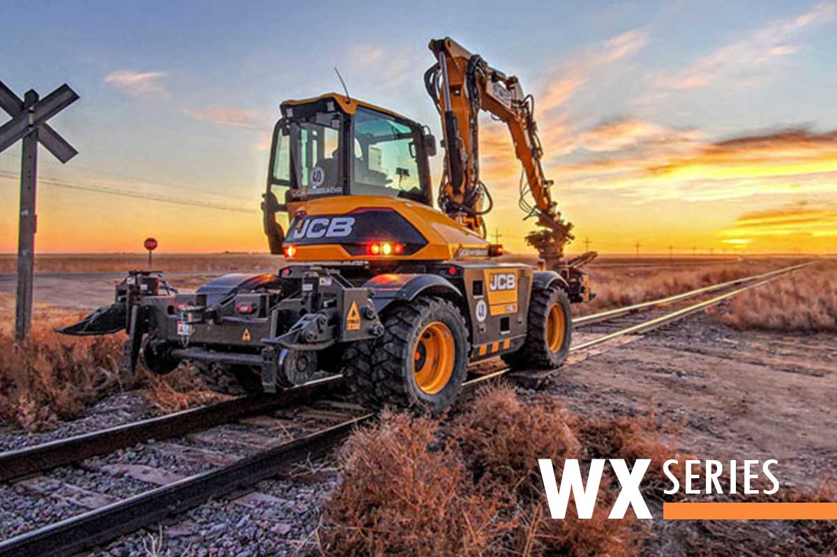 Wheel excavator equipped with DymaxRail Rail Rider WX hi-rail guidance system operating on railroad track