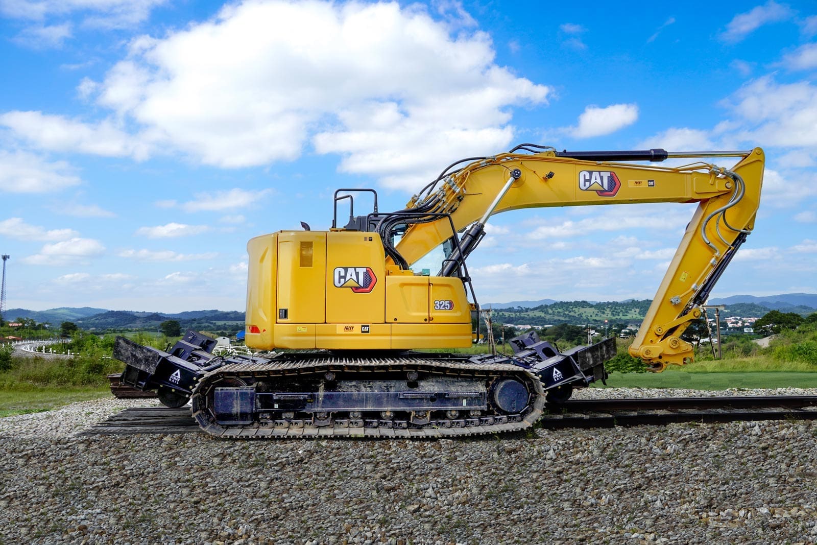 Caterpillar track excavator running on rail with a Dymax Rail Rider X2 25T detachable hi-rail system