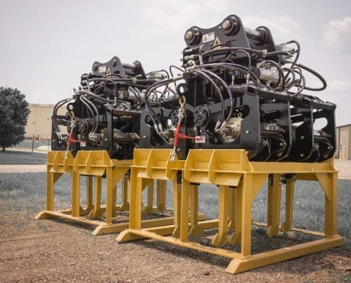 Two DymaxRail Series 67 four-motor ballast tamper attachments on transport stands staged for delivery