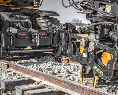 DymaxRail Series 67 ballast tamper on Cat wheel excavator with Rail Rider G-WX hi-rail system, tamping mainline track