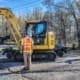 Hi-rail excavator attachment mounted on an excavator during an on-track rail maintenance orientation in Alabama.