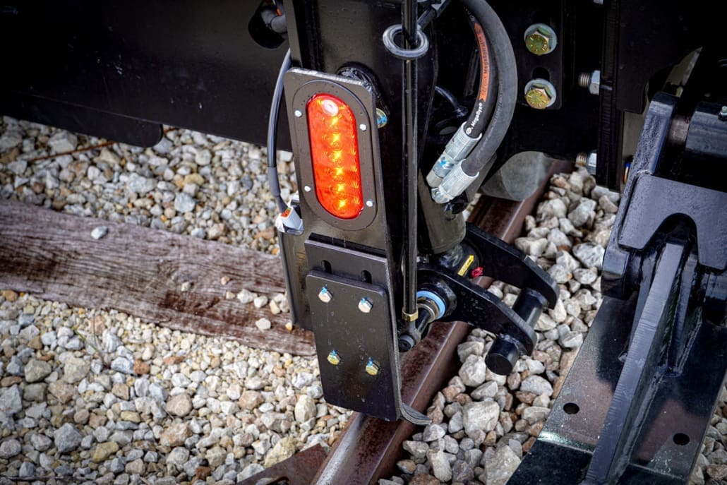 Close-up of the Dymax Rail Rider X2 12V automatic red and white directional LED lighting mounted on the hi-rail frame
