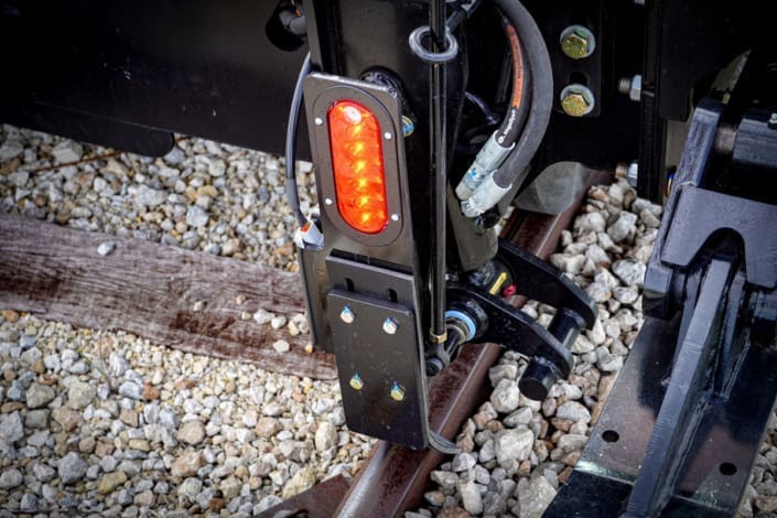 Dymax Rail Rider X2-15T solar-powered red and white directional LED lighting Close-up of the Dymax Rail Rider X2-15T solar-powered red and white directional LED lighting that illuminates track based on travel direction from a self-contained power source