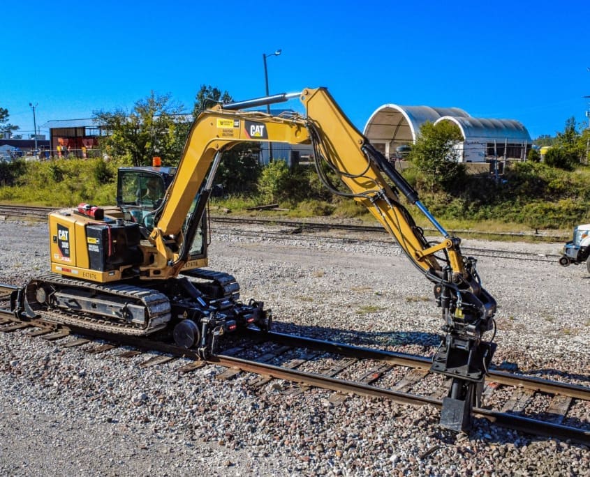 DymaxRail Rail Rider X2 Hi-Rail System – Cat 308 Track Excavator DymaxRail X2 hi-rail attachment on Cat 308 compact track excavator on railroad track