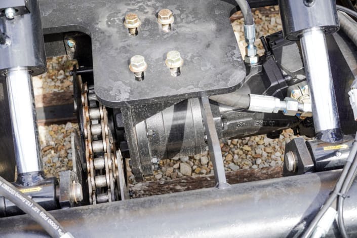 Dymax Rail Rider X2-15T 2-speed hydrostatic drive system Close-up of the Dymax Rail Rider X2-15T 2-speed hydrostatic drive system delivering 18-20 mph travel with strong towing and grade-pulling power, operated through the standard excavator travel pedals