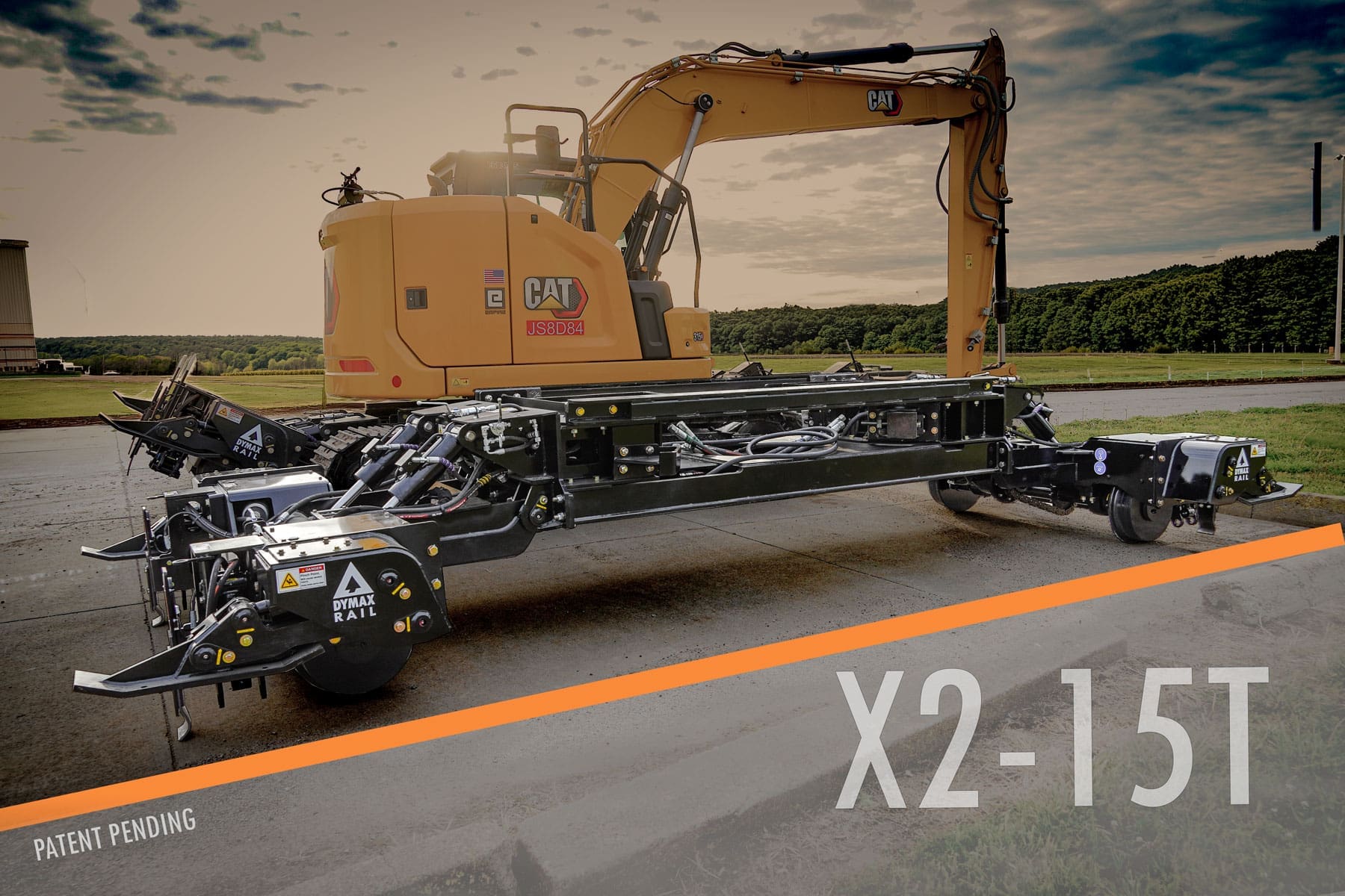Excavator with Dymax Rail Rider X2-15T hi-rail attachment Cat 315 track excavator equipped with the Dymax Rail Rider X2-15T detachable hi-rail attachment on rail in an open field